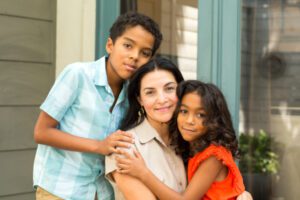 Hispanic mother laughing and talking with her children.