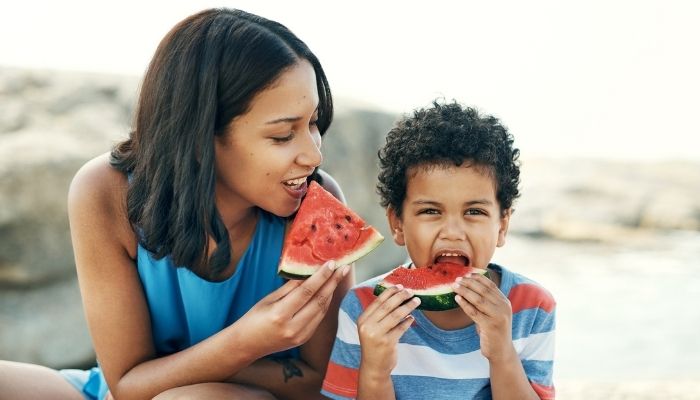 mother and son eating watermelon