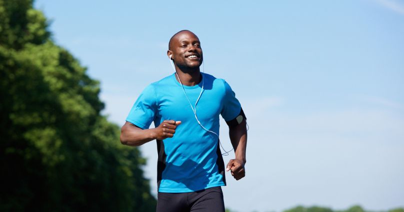 man running outside with headphones