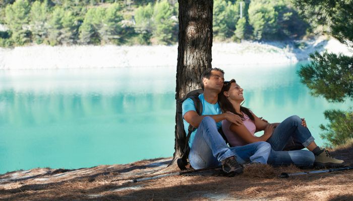 couple sitting under tree for shade | UV safety awareness