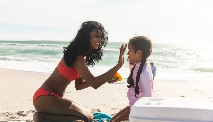 mother applying sunscreen on daughter | UV Safety Awareness