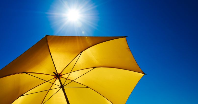 yellow umberella protecting from sun | UV Safety Awareness