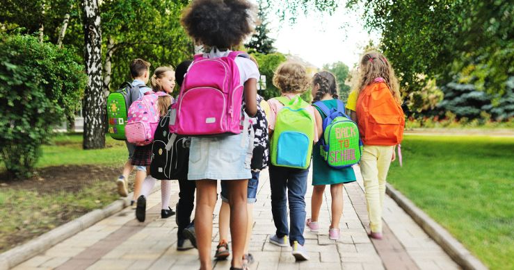 group of students walking while wearing backpacks