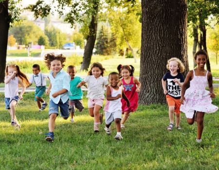 kids running smiling in a park