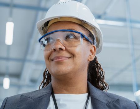 woman wearing a hard hat and safety glasses