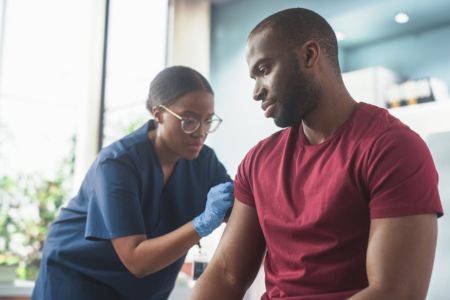 man getting vaccinated in doctors office