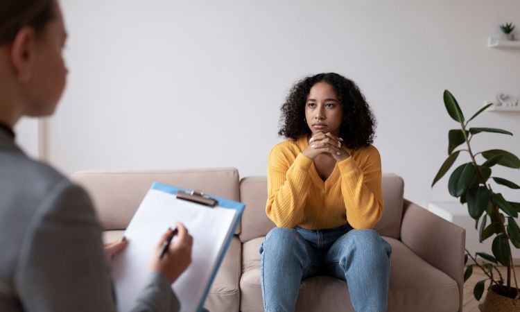 girl sitting on a couch in therapy