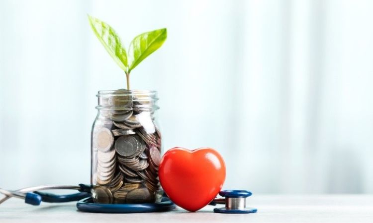 Image of a mason jar filled with coins next to a heart and a stethoscope