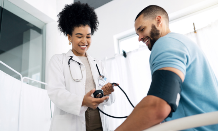 physician checking a patients blood pressure