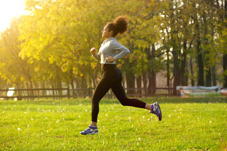 young African American jogging in a park on a sunny day